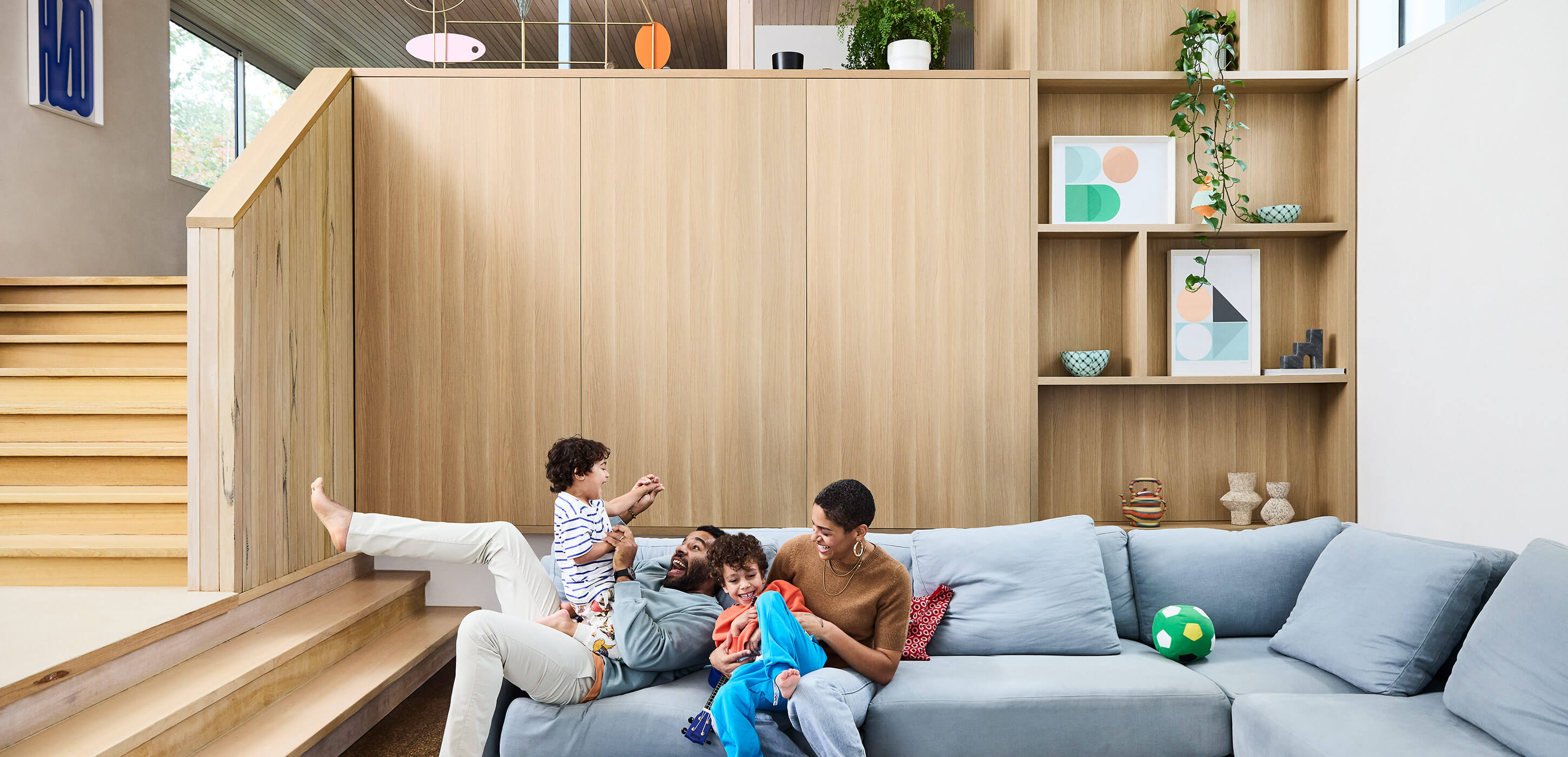 family of four playing on the sofa